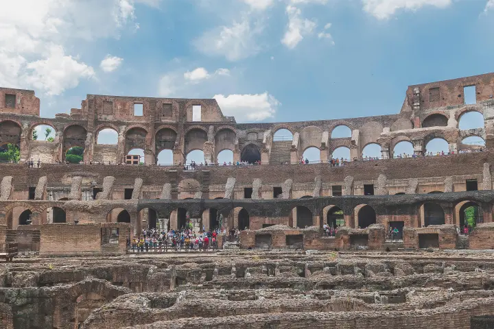 a large stone building with Colosseum in the background