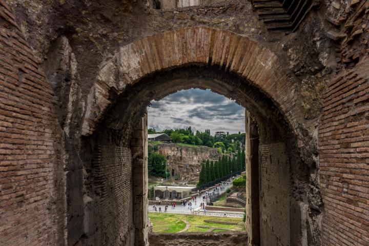 a stone building that has a bridge next to a brick wall