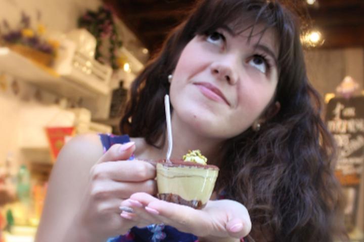 a woman eating a cake