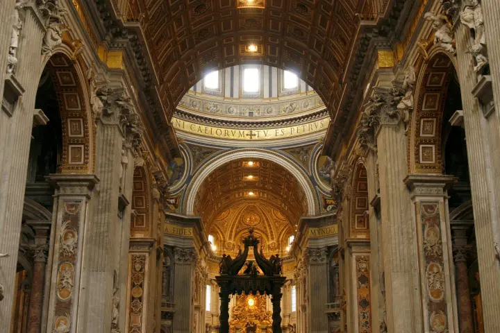 a church with a clock at the top of St. Peter's Basilica