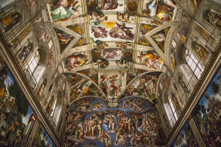 a large building with many windows with Sistine Chapel in the background