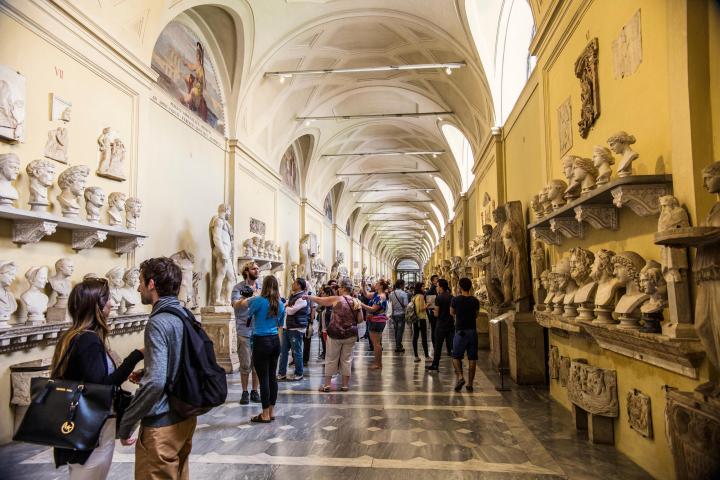 a group of people walking down a street next to a building
