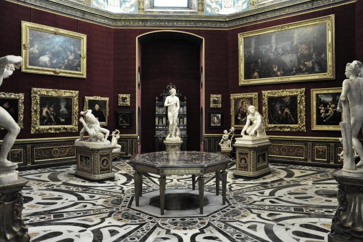 a room filled with furniture and vase of flowers on a table