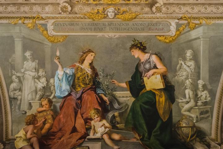 a group of people looking at a book