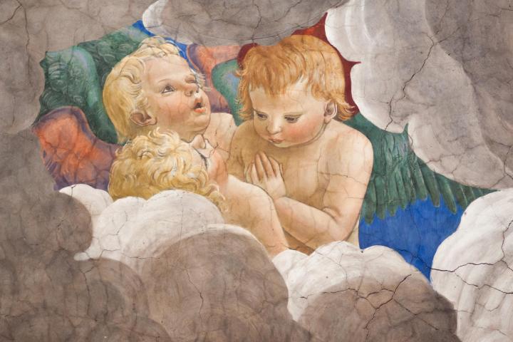 a pile of stuffed animals sitting on top of a rock