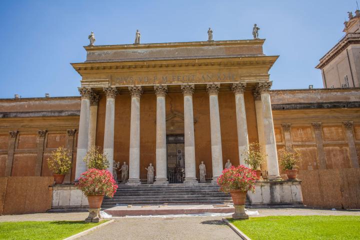 a stone statue in front of a building