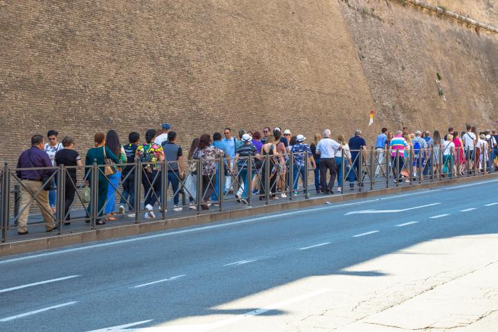 a group of people on a street in front of a crowd