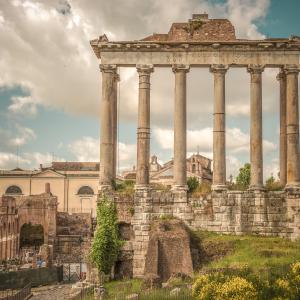 a stone building that has a bridge in the background