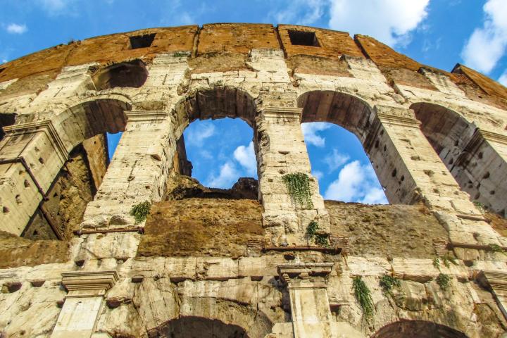 a stone building that has a clock at the top of a rock