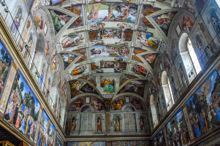a large building with many windows with Sistine Chapel in the background