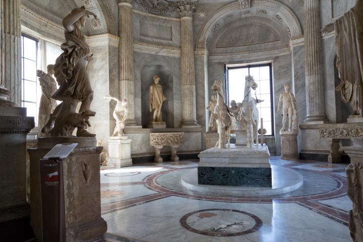 a large stone statue in front of a building