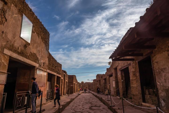 people walking on a brick building