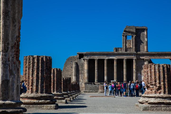 a group of people standing in front of a stone building