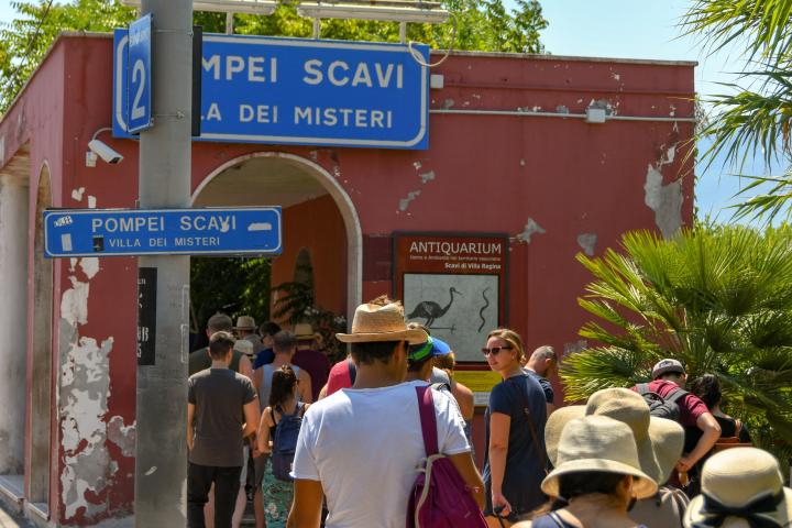 a group of people standing in front of a sign