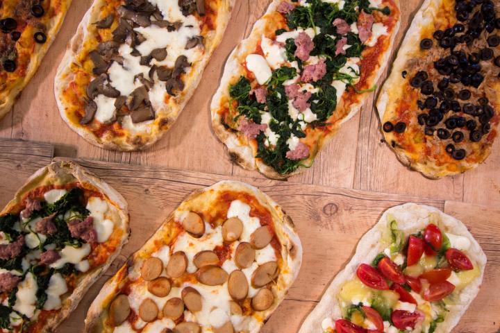 a box filled with different types of pizza