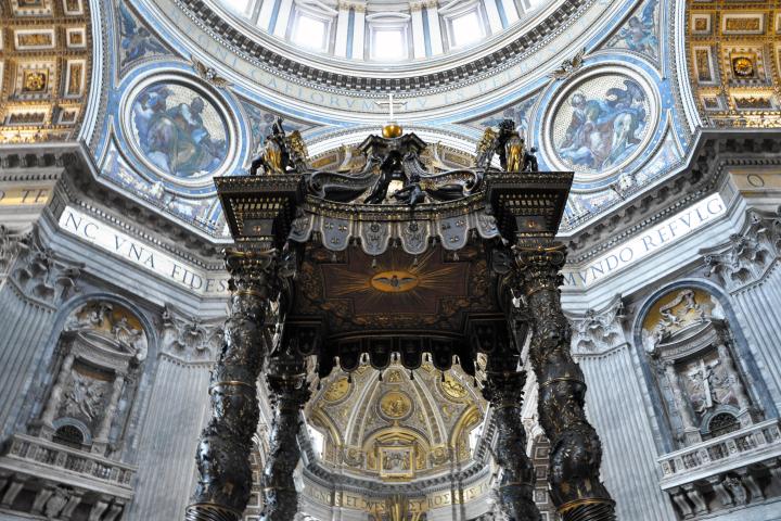 a close up of a church with St. Peter's Basilica in the background