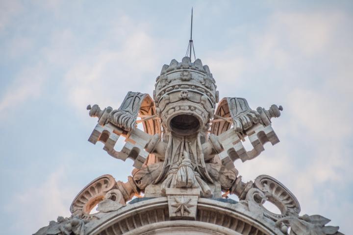 a clock tower in front of a statue