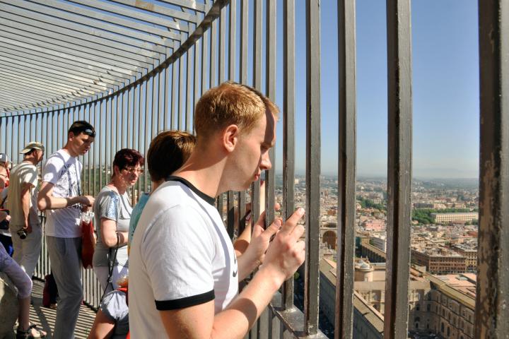 a man standing in front of a fence