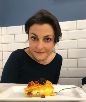a woman sitting at a table eating food
