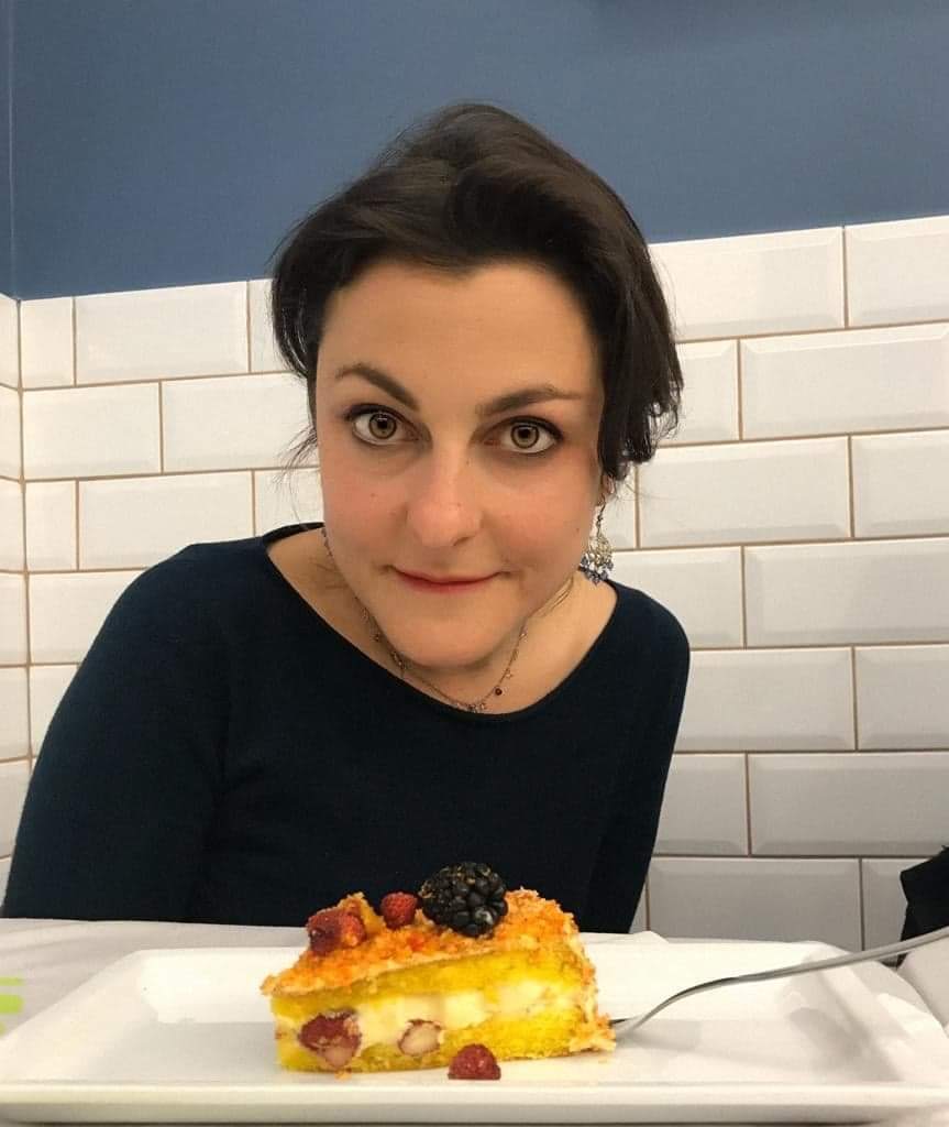 a woman sitting at a table eating food