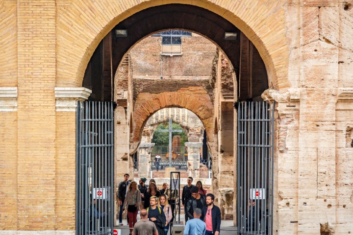 a group of people standing in front of a brick building