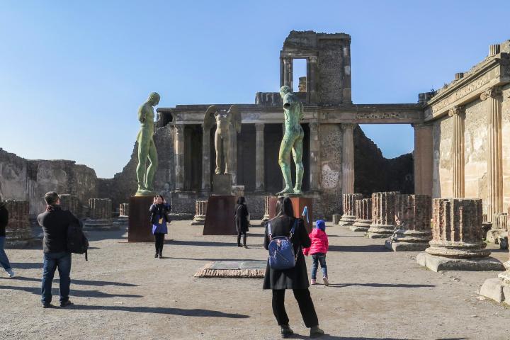 a group of people walking in front of a building