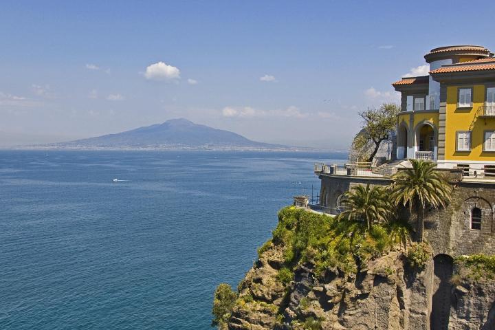 a large clock tower next to a body of water