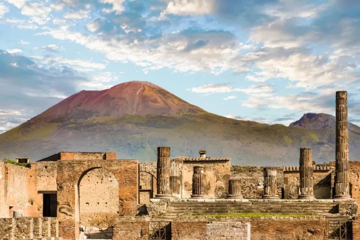 a castle like building with a mountain in the background