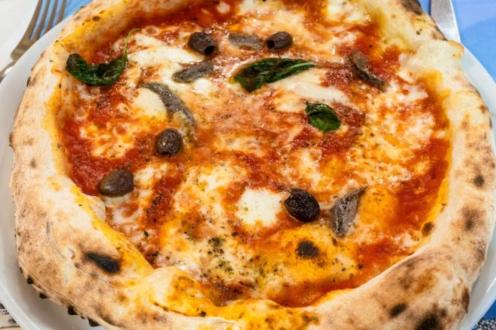 a close up of a plate of food with a slice of pizza