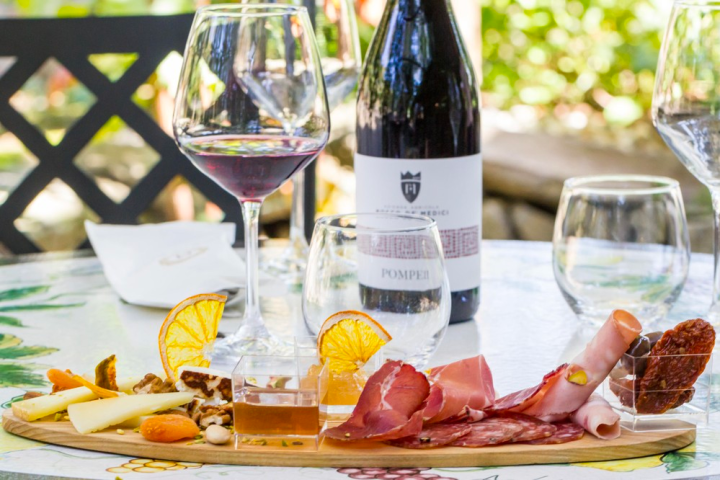 a plate of food and a bottle of wine on a table