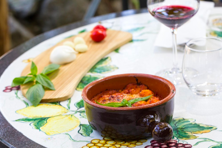 a plate of food and glasses of wine on a table