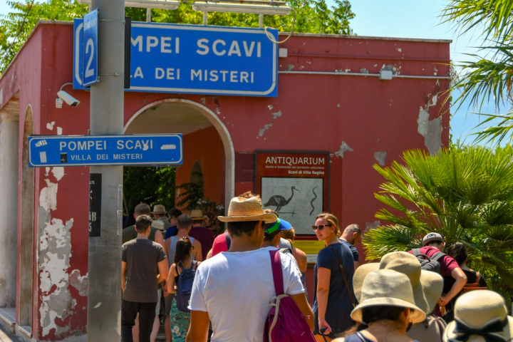 a group of people standing in front of a sign