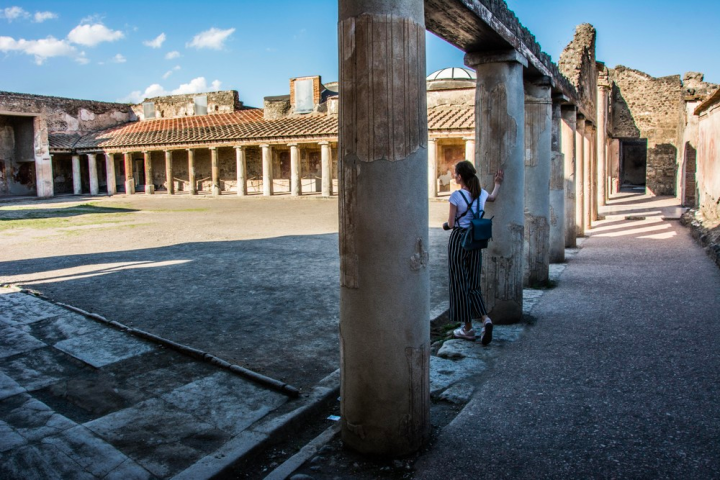 a stone building that has a bridge over a road