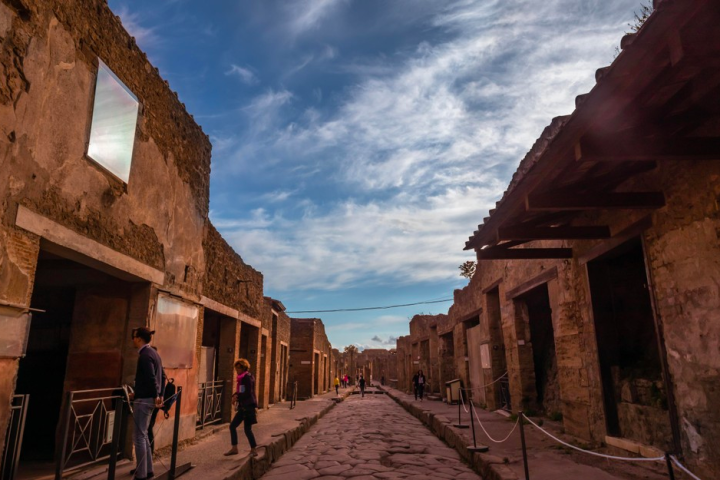 people walking on a brick building