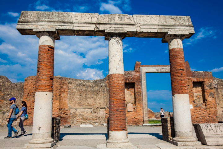 a stone bench next to a brick building