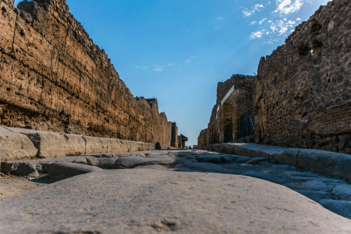a stone building with a mountain in the background