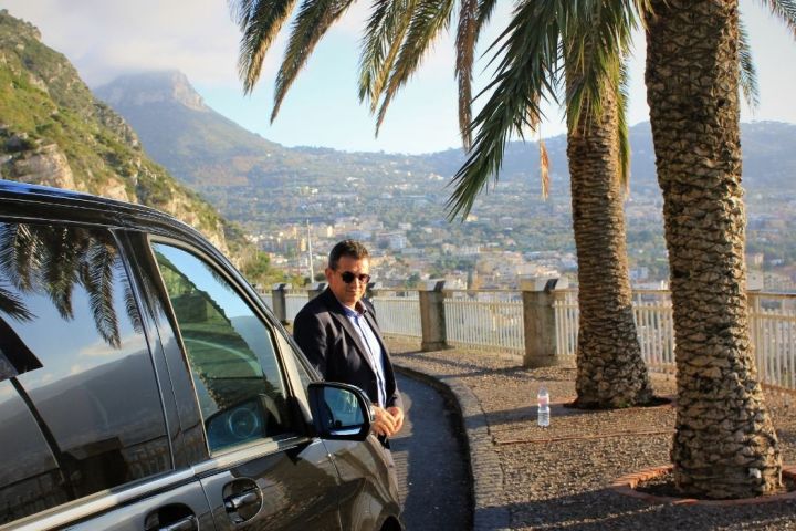 a man sitting on the side of a mountain