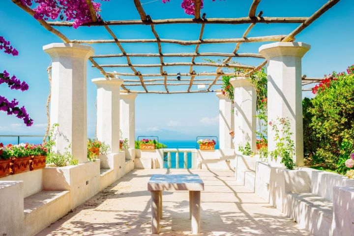 a room filled with furniture and vase of flowers on a table